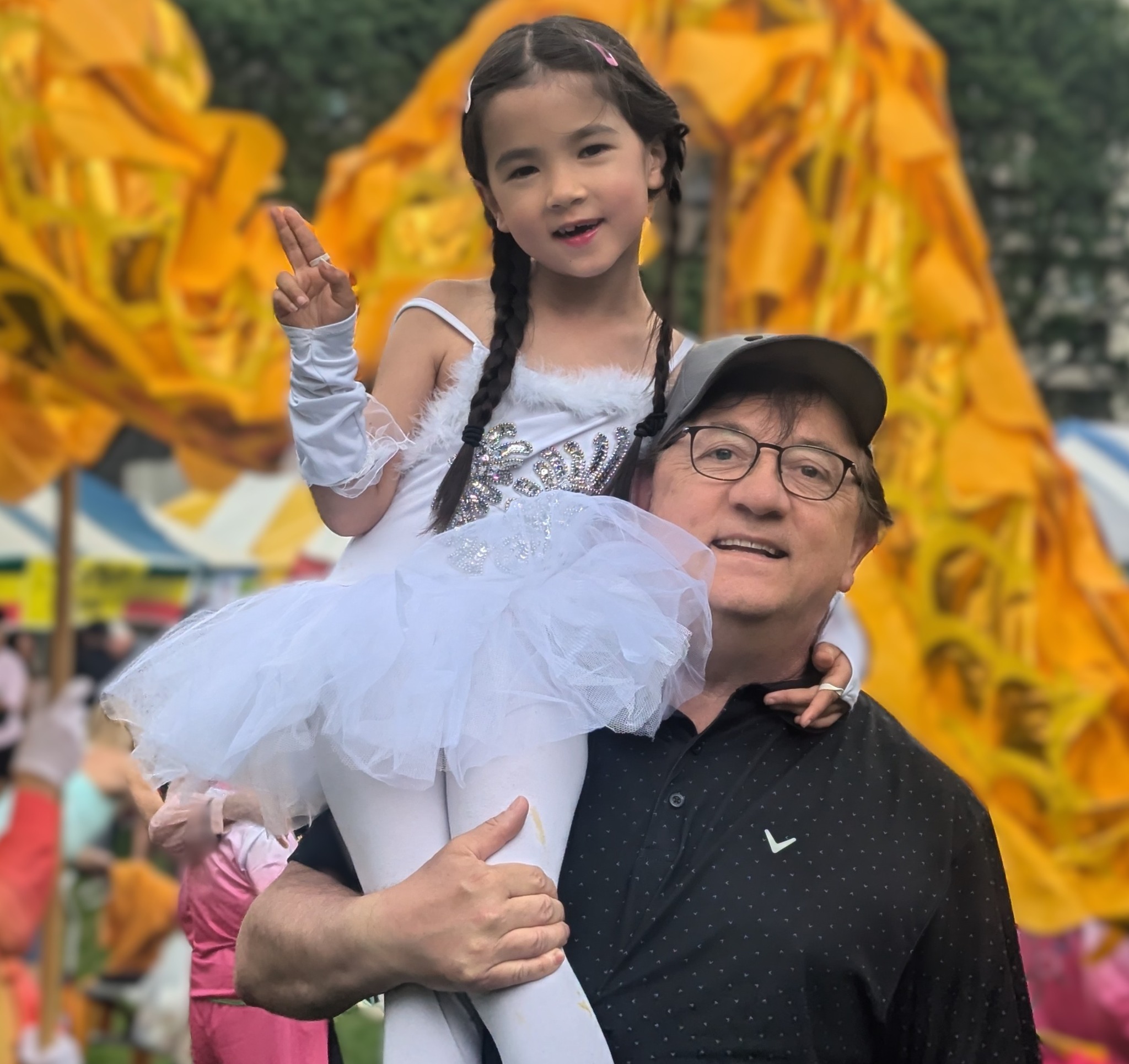 Ronald Strauss with his daughter at an outdoor festival.